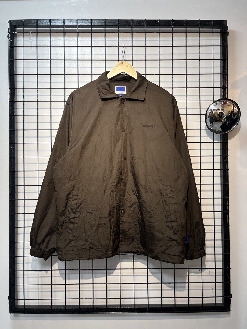 WSP Wassup Brown Coach Jacket Size L (Category: Coats, Jackets and Outerwear) located in Taal. Submitted by thrift_deals23 (Listing ID 1469185172, Image 1). Description: - Brand/Model: WSP Wassup brown coach jacket - Size: L - Details: Snap-button front closure, embroidered chest logo, regular collar, dark inner lining, and adjustable hem drawstrings with toggles - Condition: Clean piece, worn just a few times - Style: Great outer layer for daily