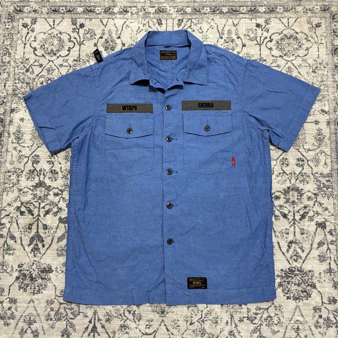 Wtaps Japan Buds 01 Chambray Shirt (Category: Activewear) located in Quezon City. Submitted by selling2survive (Listing ID 1469175190, Image 1). Description: Military-inspired fatigue build with dual button-down chest pockets, contrasting “WTAPS” and “SIERRA” name patches, branded buttons, and a woven red brand tag on the pocket Length: 27 Pit to pit: 21 Shoulder: 17 No issue .