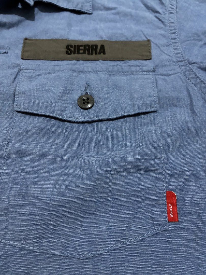 Wtaps Japan Buds 01 Chambray Shirt (Category: Activewear) located in Quezon City. Submitted by selling2survive (Listing ID 1469175190, Image 3). Description: Military-inspired fatigue build with dual button-down chest pockets, contrasting “WTAPS” and “SIERRA” name patches, branded buttons, and a woven red brand tag on the pocket Length: 27 Pit to pit: 21 Shoulder: 17 No issue .
