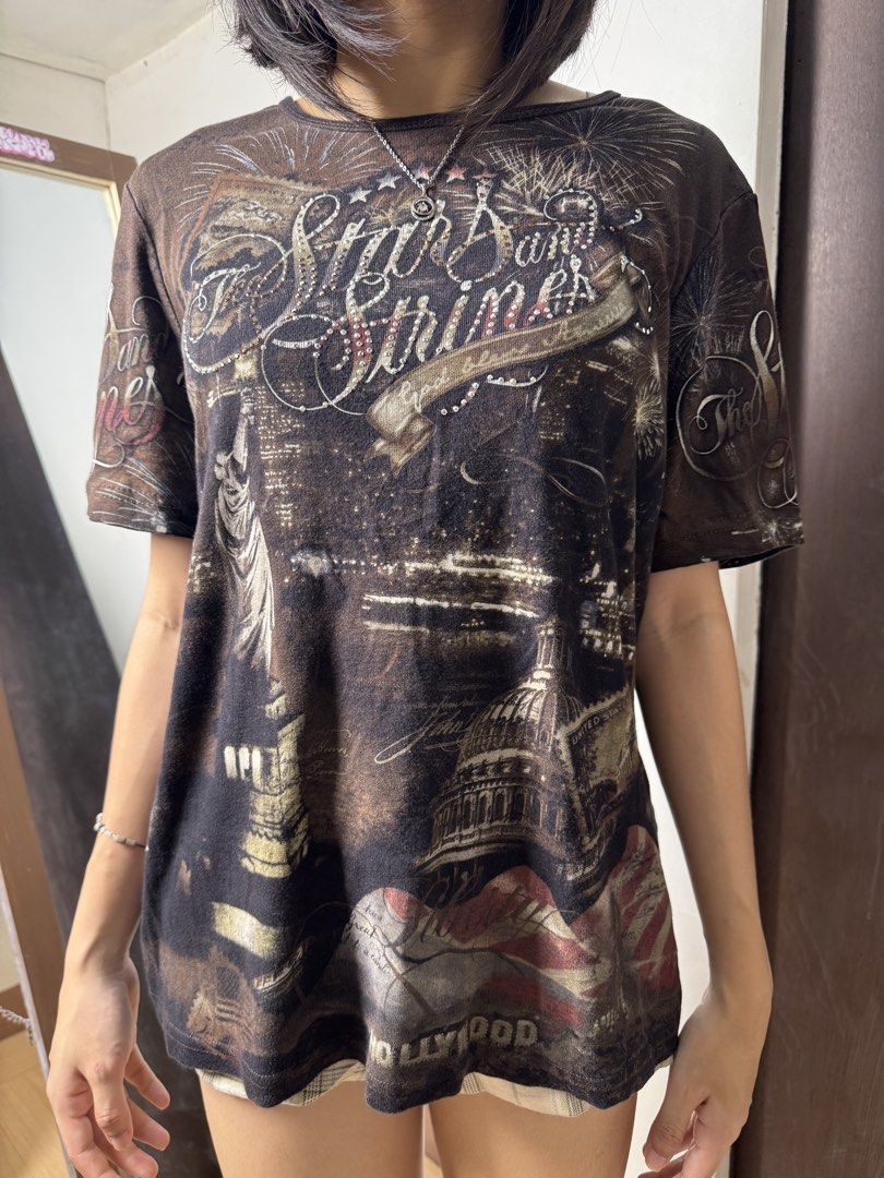 Y2K America Graphic Tee (Category: Shirts) located in Manila. Submitted by thriftz2.spaze (Listing ID 1469366601, Image 2). Description: Small-Medium bust - 36 inc length - 25 inc.