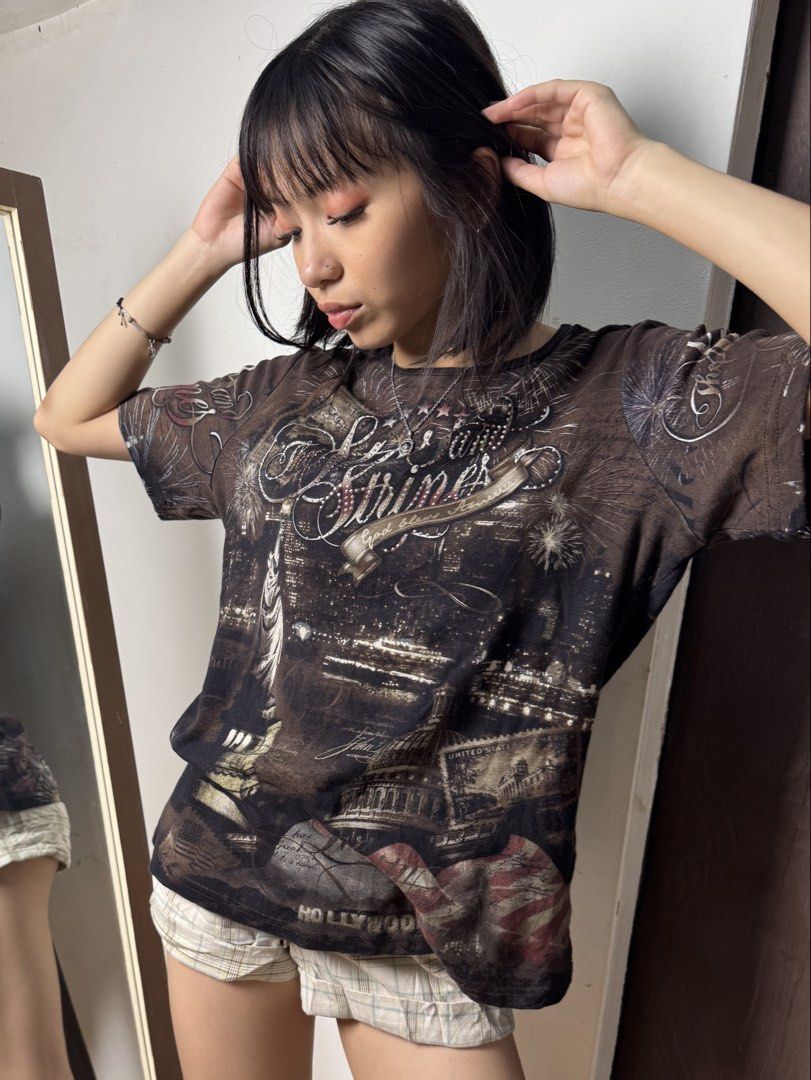 Y2K America Graphic Tee (Category: Shirts) located in Manila. Submitted by thriftz2.spaze (Listing ID 1469366601, Image 1). Description: Small-Medium bust - 36 inc length - 25 inc.