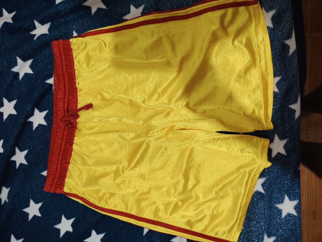 Yellow and Red Athletic Shorts (Category: Activewear) located in Cebu City. Submitted by bravetree.3f281d (Listing ID 1469220742, Image 3). Description: - Color: Bright yellow with contrasting red trim and waistband - Size: Small (inner tag) - Measurements: 14 inches flat waist, 20 inches total length - Material: Lightweight and breathable mesh fabric - Features: Matching red adjustable drawstring - Condition: Clean, no tears or stains.