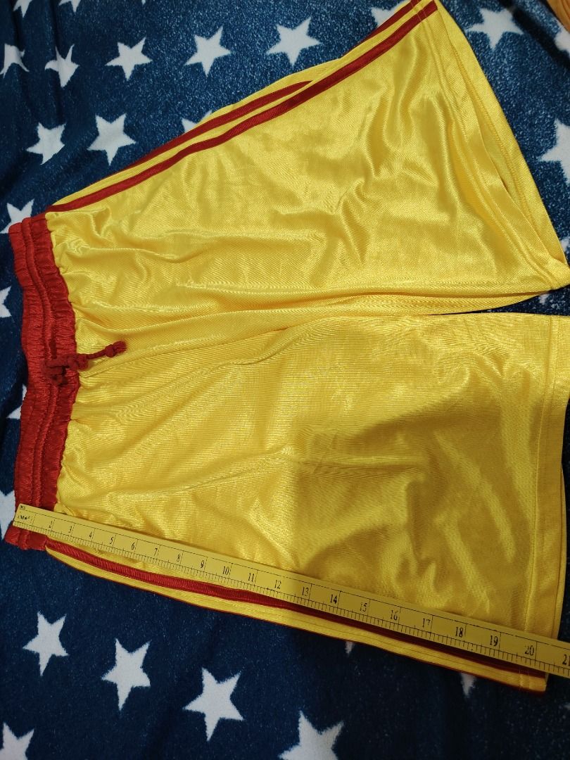 Yellow and Red Athletic Shorts (Category: Activewear) located in Cebu City. Submitted by bravetree.3f281d (Listing ID 1469220742, Image 1). Description: - Color: Bright yellow with contrasting red trim and waistband - Size: Small (inner tag) - Measurements: 14 inches flat waist, 20 inches total length - Material: Lightweight and breathable mesh fabric - Features: Matching red adjustable drawstring - Condition: Clean, no tears or stains.