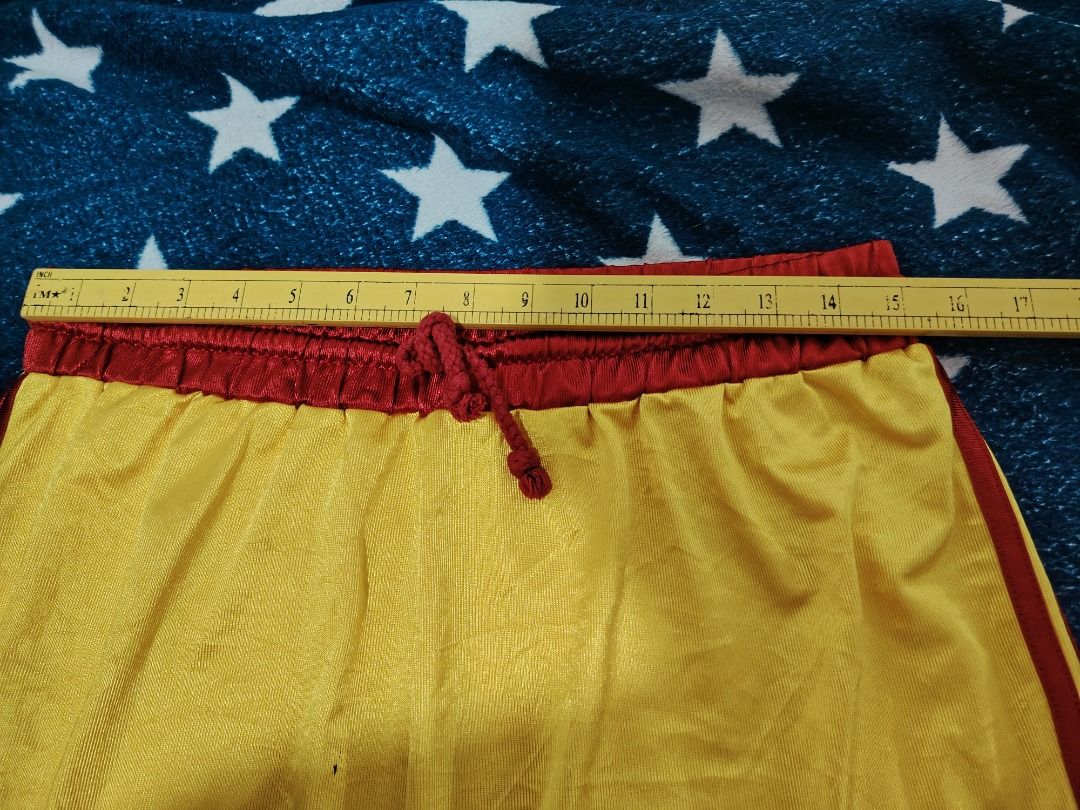 Yellow and Red Athletic Shorts (Category: Activewear) located in Cebu City. Submitted by bravetree.3f281d (Listing ID 1469220742, Image 2). Description: - Color: Bright yellow with contrasting red trim and waistband - Size: Small (inner tag) - Measurements: 14 inches flat waist, 20 inches total length - Material: Lightweight and breathable mesh fabric - Features: Matching red adjustable drawstring - Condition: Clean, no tears or stains.