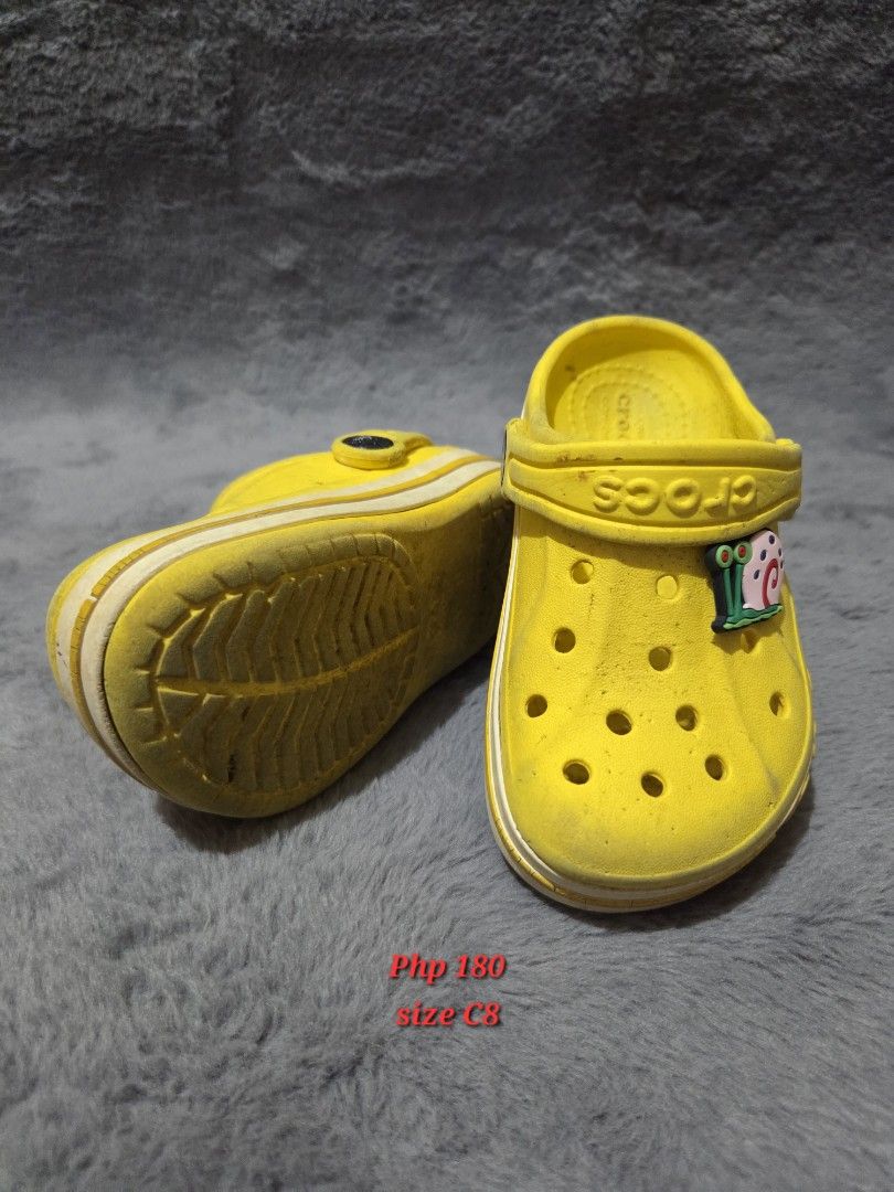 Yellow Crocs Kids (Category: Babies & Kids Fashion) located in Bulacan. Submitted by gtrvddg (Listing ID 1469222967, Image 1). Description: - Item: Kids' Classic Crocs - Color: Bright Yellow - Size: C8 - Extras: Includes Jibbitz charm - Design: Slip-on style with ventilation holes for breathability - Condition: Moderate signs of wear on soles and uppers from active use.