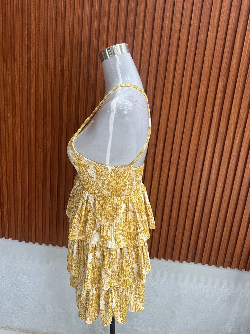 Yellow Floral Ruffled Mini Dress (Category: Dresses) located in Manila. Submitted by cherish_24 (Listing ID 1469215577, Image 2). Description: - Vibrant yellow sundress with a leafy floral print - Sleeveless with trendy crisscross open back - V-neckline with a cute center front slit - Multi-tiered ruffled skirt for a playful flow - Lightweight fabric with fine vertical pleats - Easy slip-on style with a flexible smocked back band.