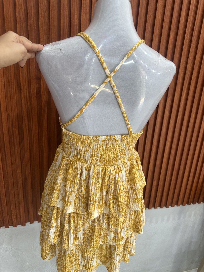 Yellow Floral Ruffled Mini Dress (Category: Dresses) located in Manila. Submitted by cherish_24 (Listing ID 1469215577, Image 3). Description: - Vibrant yellow sundress with a leafy floral print - Sleeveless with trendy crisscross open back - V-neckline with a cute center front slit - Multi-tiered ruffled skirt for a playful flow - Lightweight fabric with fine vertical pleats - Easy slip-on style with a flexible smocked back band.