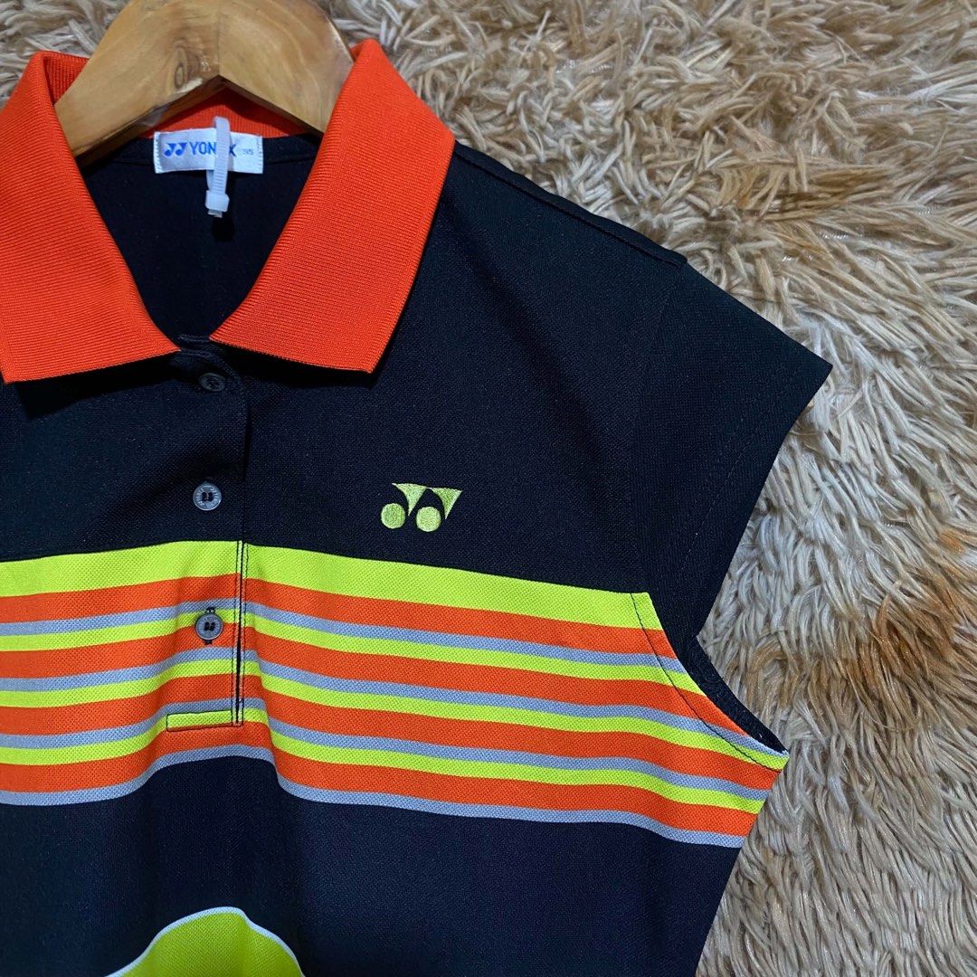 YONEX ACTIVE SLEEVELESS POLO SHIRT (Category: Activewear) located in Butuan. Submitted by jc13thrifts (Listing ID 1469306664, Image 2). Description: - Brand: YONEX - Style: Active Sleeveless Polo Shirt - Size: 95 - Color: Black with orange, neon yellow, and grey accents - Features: Collared neck with button placket, embroidered Yonex logo, 'ACTIVE SPORT' graphic print - Condition: Excellent pre-loved condition, lightweight and breathable fabric -