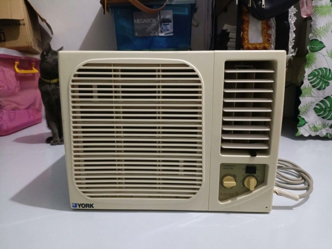 York Window Type Air Conditioner (Category: Air Conditioning and Heating) located in Caloocan City. Submitted by parungaoai70385 (Listing ID 1469330573, Image 1). Description: - Brand: York window type air conditioner - Color: Off-white housing with front grille - Controls: Manual rotary dials for thermostat and fan - Features: Adjustable side louvers and attached power cord - Condition: Cools effectively - Size: Standard compact size, perfect fo