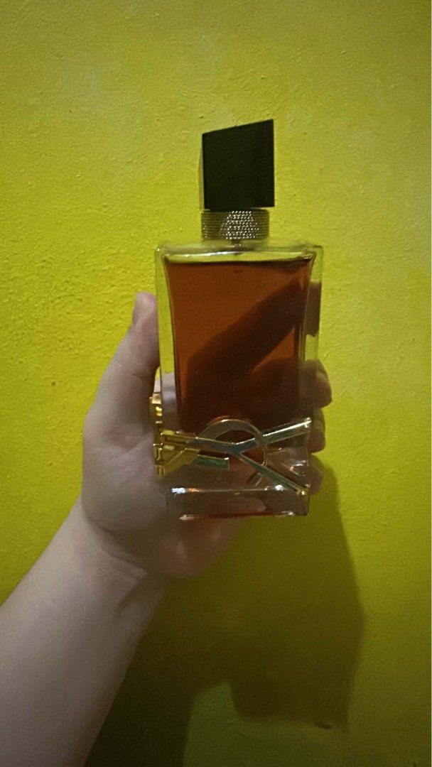 Yves Saint Laurent Libre Eau de Parfum Intense (Category: Fragrance & Deodorants) located in Manila. Submitted by mikamika.chu (Listing ID 1469168052, Image 1). Description: Few sprays missing with box good as new - Brand: Yves Saint Laurent (YSL) Libre Intense - Size: Large bottle (full level visible) - Scent Profile: Rich floral and vanilla notes - Design: Iconic gold wrap-around YSL logo with black asymmetrical cap and gold chain detail - Cond