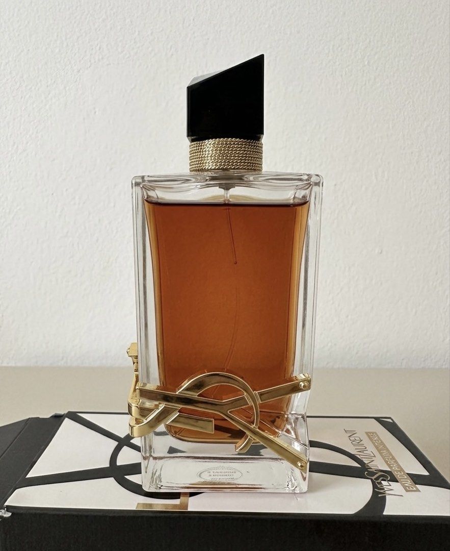 Yves Saint Laurent Libre Eau de Parfum Intense (Category: Fragrance & Deodorants) located in Manila. Submitted by mikamika.chu (Listing ID 1469168052, Image 2). Description: Few sprays missing with box good as new - Brand: Yves Saint Laurent (YSL) Libre Intense - Size: Large bottle (full level visible) - Scent Profile: Rich floral and vanilla notes - Design: Iconic gold wrap-around YSL logo with black asymmetrical cap and gold chain detail - Cond