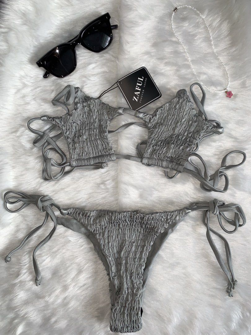 Zaful Gray Smocked Tie Side Bikini Set (Category: Bikinis & Swimsuits) located in Mandaluyong City. Submitted by gentle.segoviajam (Listing ID 1469324186, Image 3). Description: - Condition: Brand new with tags (unworn) - Color: Gray - Material: Heavy smocked texture - Top: Star-like cups with cutouts and thin straps - Bottom: Adjustable tie sides - Best for: Beach days and pool parties.