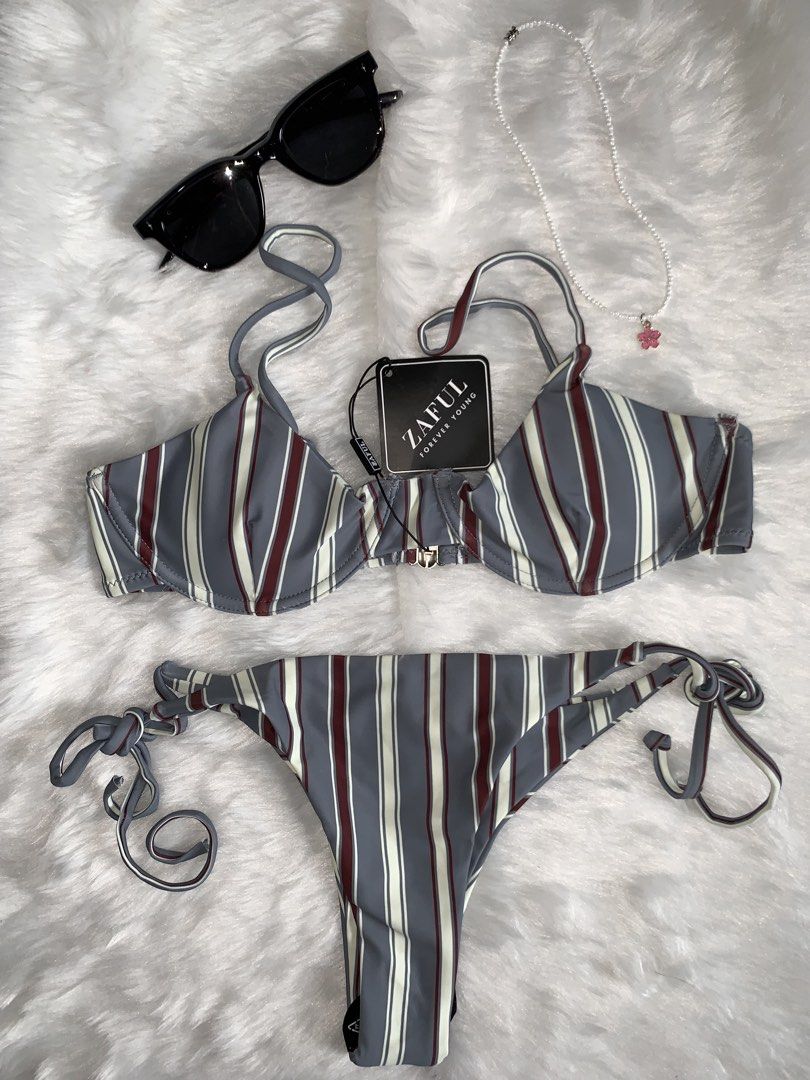 Zaful Striped Underwire Bikini Set (Category: Bikinis & Swimsuits) located in Mandaluyong City. Submitted by gentle.segoviajam (Listing ID 1469325676, Image 1). Description: - Brand: Zaful - Item: Striped bikini set - Colors: Grey, maroon, and white - Top: Underwire with adjustable straps - Bottoms: Matching tie-side - Condition: Brand new with original tags attached, never worn.