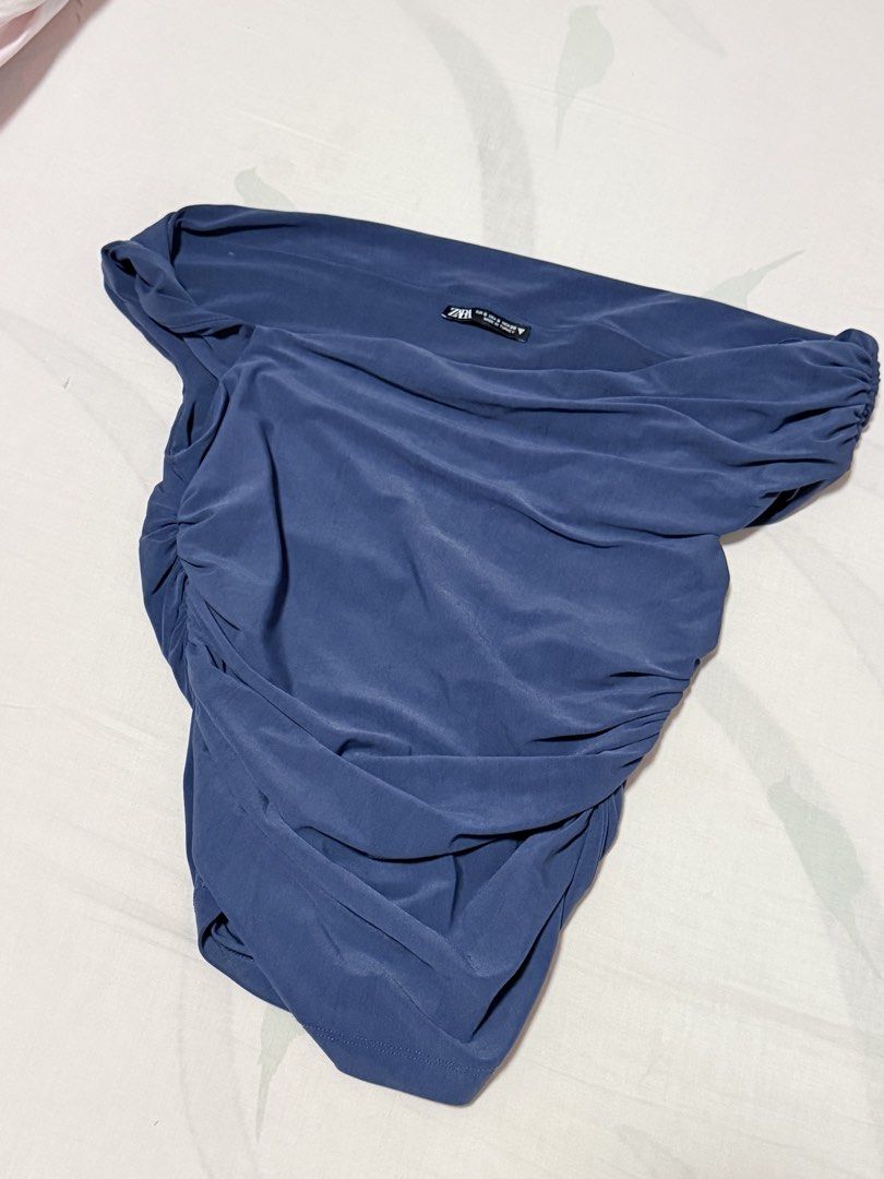 Zara asymmetric drape blue top (Category: Sleeveless) located in Manila. Submitted by livvydeclutters (Listing ID 1469310139, Image 3). Description: - Brand: Zara - Color: Dark Blue - Size: S - Style: Off-the-shoulder, asymmetric cut, all-over ruching - Fabric: Stretchy and super comfortable - Condition: Worn only once, freshly washed, and properly stored.