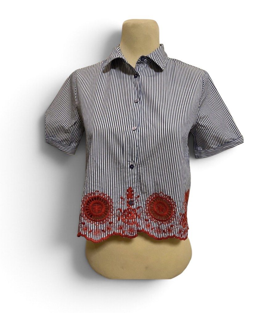 Zara Basic Blue White Striped Embroidered Short Sleeve Shirt (Category: Shirts) located in Quezon City. Submitted by letsdeclutter101 (Listing ID 1469380854, Image 2). Description: - Brand: Zara Basic - Size: Small (S) - Design: Blue and white vertical stripes - Features: Short sleeves with folded cuffs, collared neck, front button closure - Detail: Red embroidered cut-out detail along the scalloped hemline.