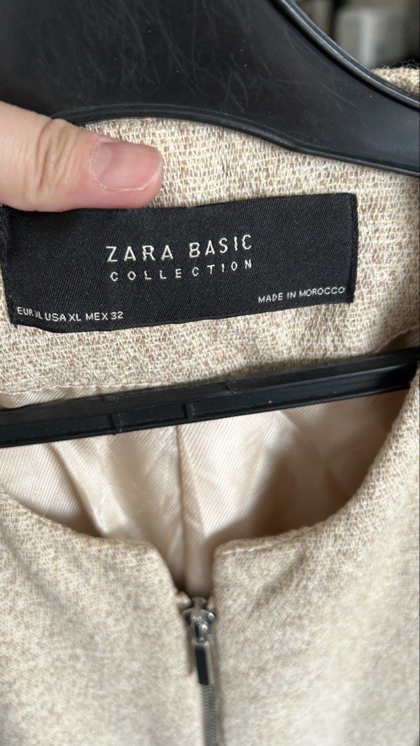 Zara Basic Collection Beige Tweed Zip Jacket Size XL (Category: Coats, Jackets and Outerwear) located in Pasig City. Submitted by eenamagg (Listing ID 1469357220, Image 3). Description: - Brand: Zara Basic Collection - Size: EUR XL / USA XL / MEX 32 - Material/Style: Beige textured tweed fabric with clean interior lining - Closure: Full front silver metal zipper - Pockets: Two functional front pockets with silver zippers - Design: Classic collarl