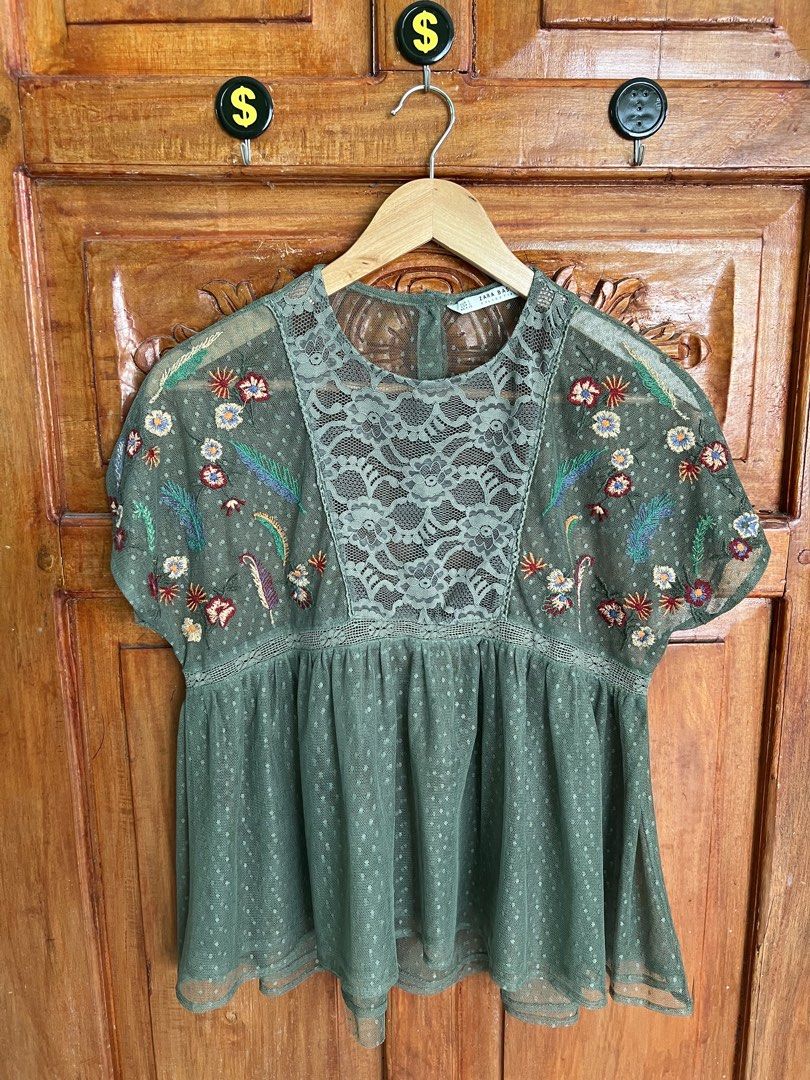 Zara Basic Collection Olive Green Embroidered Mesh Blouse Size S (Category: Blouses) located in San Fernando. Submitted by prettyfinds2021 (Listing ID 1469302942, Image 1). Description: - Brand: Zara Basic Collection - Size: Small (EUR S, USA S, MEX 26) - Color: Olive green - Material: Lightweight sheer mesh with dot pattern - Details: Floral embroidered short sleeves, front lace panel, round neckline with back button closure.