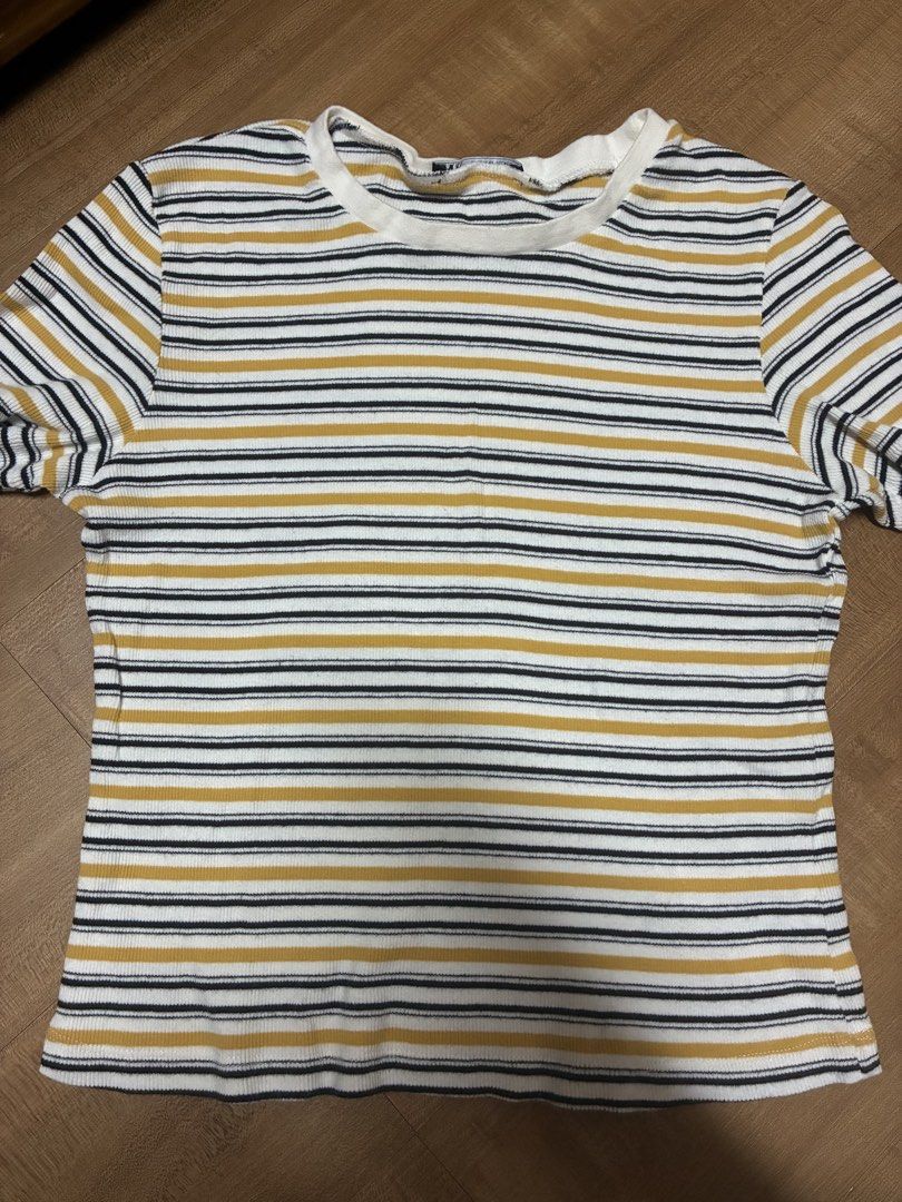 Zara basic yellow Striped Ribbed Short Sleeve T-shirt (Category: Shirts) located in Quezon City. Submitted by habits.mnl (Listing ID 1469233581, Image 1). Description: Large on tag fits s-m - Color/Pattern: White with mustard yellow and black horizontal stripes - Material: Soft, stretchy ribbed knit - Fit: Standard fit with a classic round neckline - Style: Versatile basic, perfect for layering or pairing with jeans and skirts - Condition: Clean 