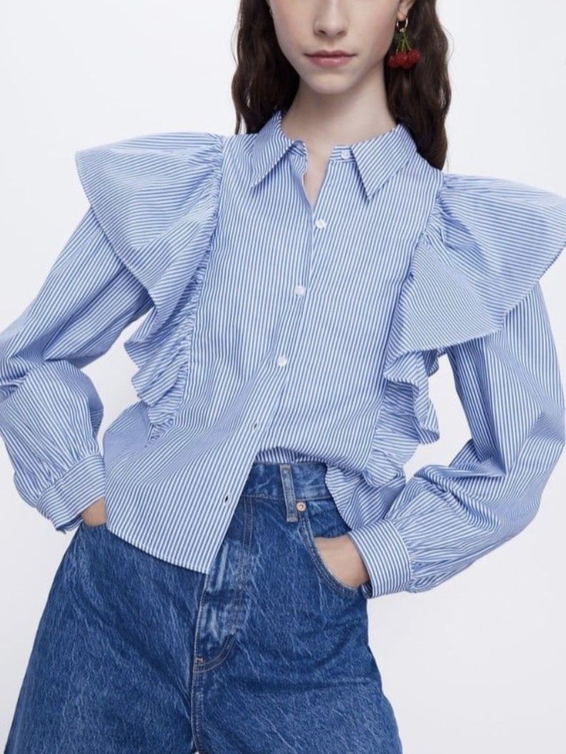 ZARA Blue White Striped Ruffled Blouse (Category: Blouses) located in General Santos City (Dadiangas). Submitted by amzonshop (Listing ID 1469241511, Image 1). Description: - Color/Pattern: Blue and white vertical stripes - Design: Dramatic oversized ruffled shoulders and matching front placket ruffles - Fit: Cropped length, ideal for high-waisted denim - Details: Classic pointed collar and buttoned cuffs - Material: Lightweight cotton blend with