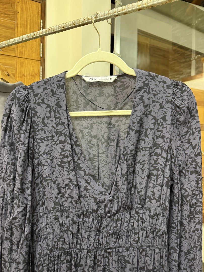 Zara Boho Grey Floral Maxi Dress (Category: Dresses) located in Manila. Submitted by kjscloset_ (Listing ID 1469341012, Image 3). Description: NO LOWBALLING ‼️ Issues: Loose garter on both sleeves RFS: Decluttering Price is negotiable Payment first (Gcash only) Zara grey maxi dress featuring a dark floral print, deep V-neckline, long sleeves, and a flattering smocked waist. Includes a front button placket and leg slit. Size XXS, lightweight, and 