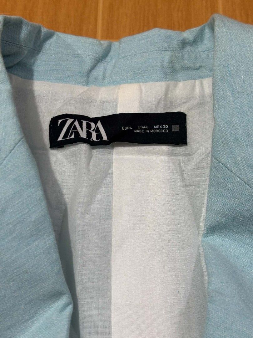Zara Light Blue Blazer Jacket Size L (Category: Coats, Jackets and Outerwear) located in Paranaque City. Submitted by poego (Listing ID 1469268841, Image 2). Description: - Brand: Zara - Size: L - Material: Cotton & polyester blend - Design: Single-breasted with two dark buttons and front flap pockets - Color: Light blue (great for work or casual wear) - Condition: Excellent.