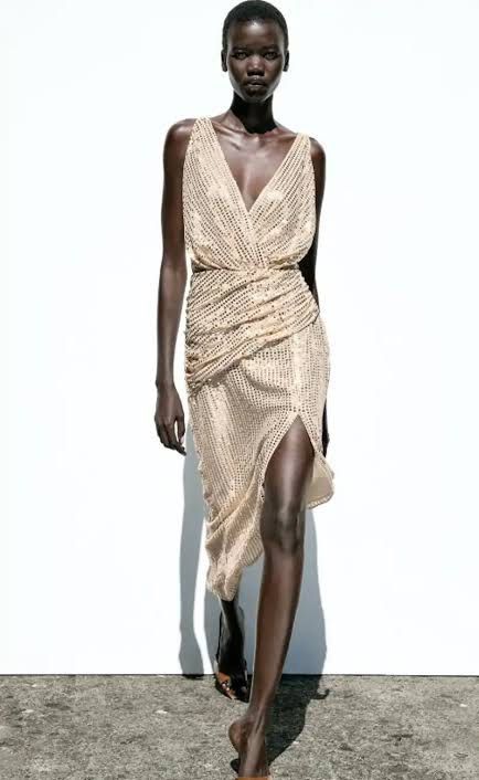 Zara Sequined V-Neck Dress (Category: Dresses) located in Cainta. Submitted by qualityyetaffordable (Listing ID 1469174425, Image 1). Description: - Brand: Zara - Style: Sequined midi dress - Color: Champagne gold - Size: XS to small - Condition: Brand new with tags (BNWT) - Details: Deep V-neck wrap front, ruched draping, side slit, and low drape back with adjustable tie strings.