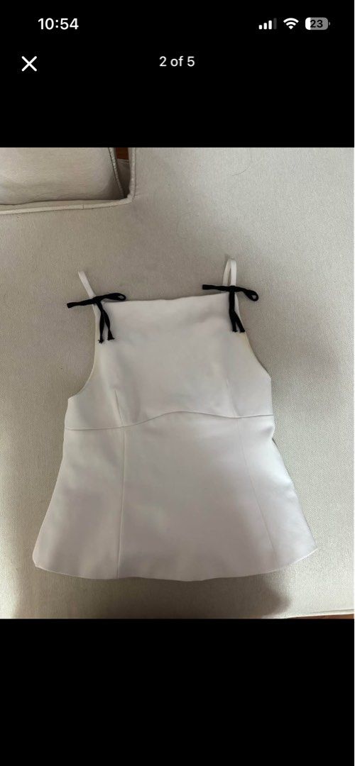 Zara Strappy Top With Bow (Category: Sleeveless) located in Manila. Submitted by minalovely (Listing ID 1469181322, Image 3). Description: - Original Price: 3,420 - Price Now: 1k - Brand: Zara - Style: Peplum tank top with square neckline and thin straps - Details: Adorable black ribbon tied at each shoulder, hidden side zipper closure - Size: S (fits true to size) - Condition: Clean and well-maintained.