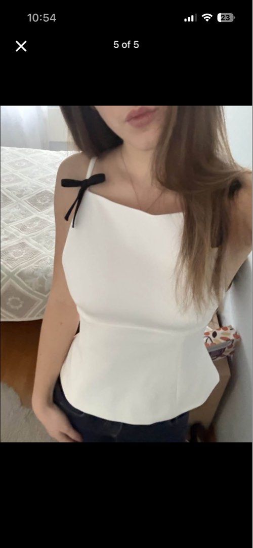 Zara Strappy Top With Bow (Category: Sleeveless) located in Manila. Submitted by minalovely (Listing ID 1469181322, Image 2). Description: - Original Price: 3,420 - Price Now: 1k - Brand: Zara - Style: Peplum tank top with square neckline and thin straps - Details: Adorable black ribbon tied at each shoulder, hidden side zipper closure - Size: S (fits true to size) - Condition: Clean and well-maintained.