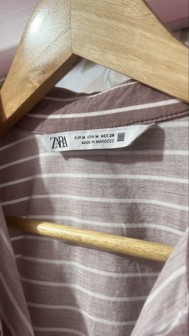 Zara Striped Button Down Shirt Medium (Category: Shirts) located in Pasig City. Submitted by morilove (Listing ID 1469163203, Image 2). Description: - Brand: Zara - Color: Pink and white stripes - Size: Medium (M) - Fit: Oversized with cuffed sleeves and curved hem - Details: Two front chest pockets, mixed vertical and horizontal stripes on the back yoke - Origin: Made in Morocco - Condition: Excellent pre-loved condition (ready to ship!).