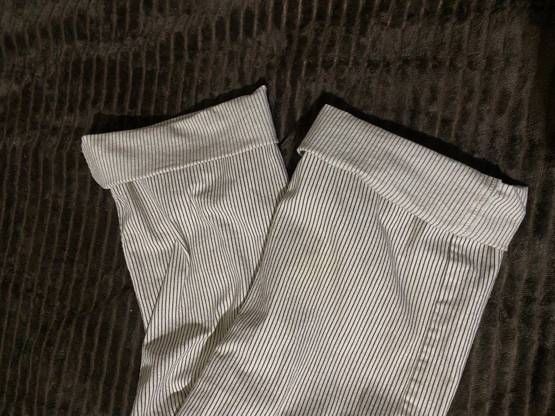 Zara Striped Pants (Category: Jeans) located in Iloilo. Submitted by luckyeagle_1c5618 (Listing ID 1469295790, Image 3). Description: - Brand: Zara - Style: Classic straight leg pants - Color/Pattern: White with thin black vertical stripes - Closure: Standard button and zipper - Condition: Clean fabric with minimal wear - Versatile neutral piece, pairs easily with any basic top.