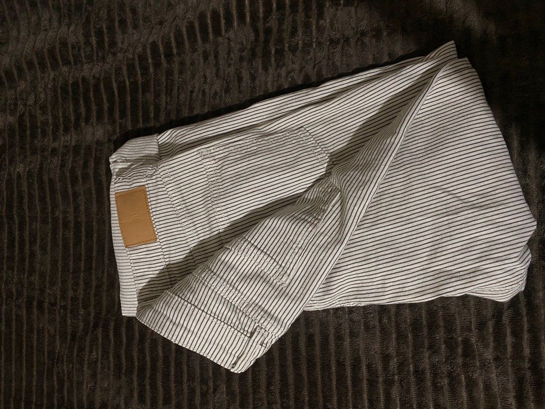 Zara Striped Pants (Category: Jeans) located in Iloilo. Submitted by luckyeagle_1c5618 (Listing ID 1469295790, Image 2). Description: - Brand: Zara - Style: Classic straight leg pants - Color/Pattern: White with thin black vertical stripes - Closure: Standard button and zipper - Condition: Clean fabric with minimal wear - Versatile neutral piece, pairs easily with any basic top.