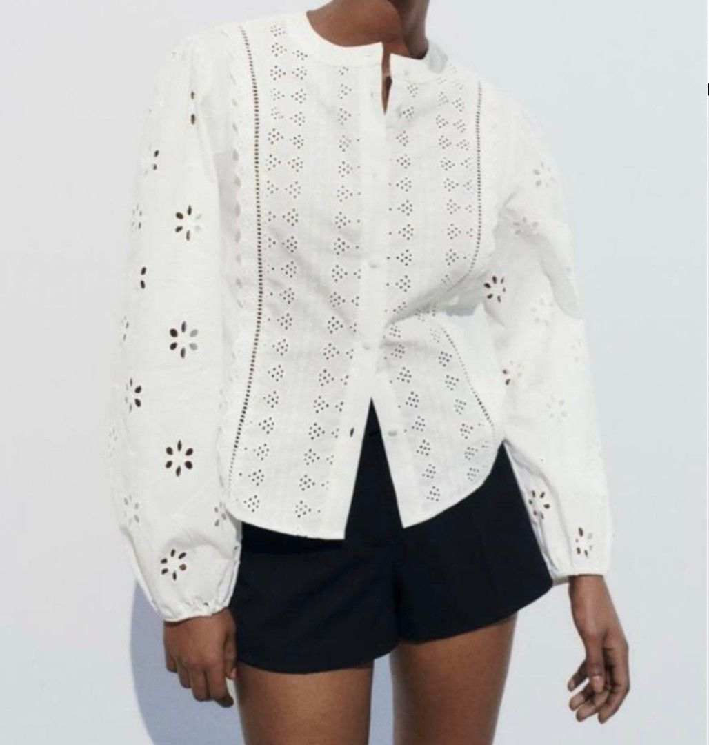 Zara White Embroidered Eyelet Blouse Size M (Category: Blouses) located in Pasig City. Submitted by 35th.store (Listing ID 1469162981, Image 1). Description: - Brand: Zara - Color: Classic White - Size: Medium (EUR M, USA M, MEX 28) - Standard fit - Design: Intricate eyelet embroidery and cutwork details throughout - Features: Round neckline, long balloon sleeves with gathered elastic cuffs - Fabric: Lightweight and breathable - Styling: Perfect 