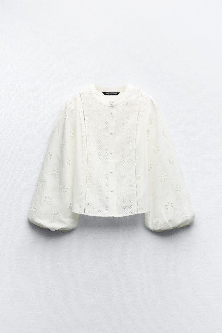 Zara White Embroidered Eyelet Blouse Size M (Category: Blouses) located in Pasig City. Submitted by 35th.store (Listing ID 1469162981, Image 2). Description: - Brand: Zara - Color: Classic White - Size: Medium (EUR M, USA M, MEX 28) - Standard fit - Design: Intricate eyelet embroidery and cutwork details throughout - Features: Round neckline, long balloon sleeves with gathered elastic cuffs - Fabric: Lightweight and breathable - Styling: Perfect 