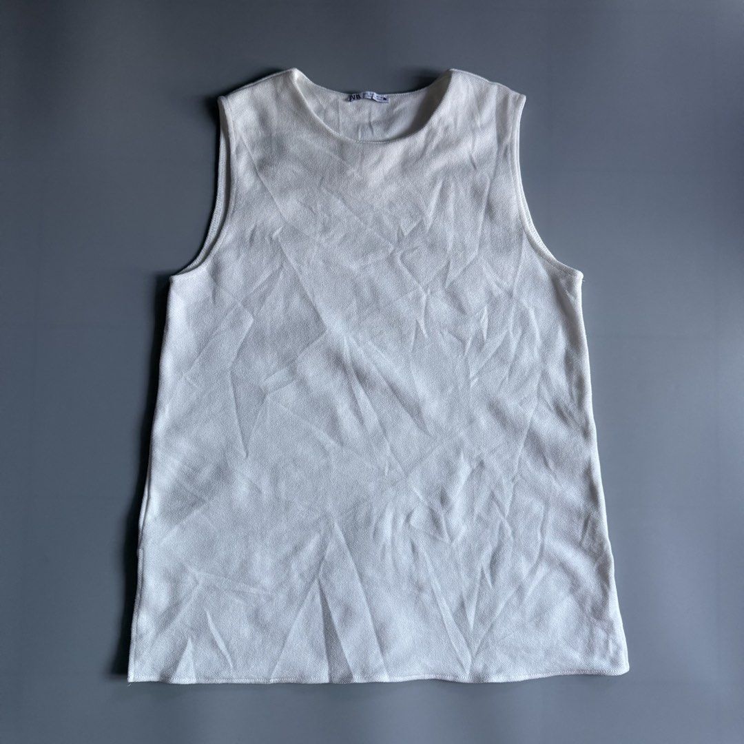 Zara White Knit Tank Top Size L (Category: Sleeveless) located in Benito Soliven. Submitted by markedasdifferent (Listing ID 1469252562, Image 1). Description: - Brand: Zara (Inditex Group) - Color: White - Size: L (fits standard) - Style: Knitted tank top, round neckline, sleeveless - Origin: Made in Turkey -19/28.5 - Condition: Clean, excellent pre-loved condition - Perfect everyday basic piece.