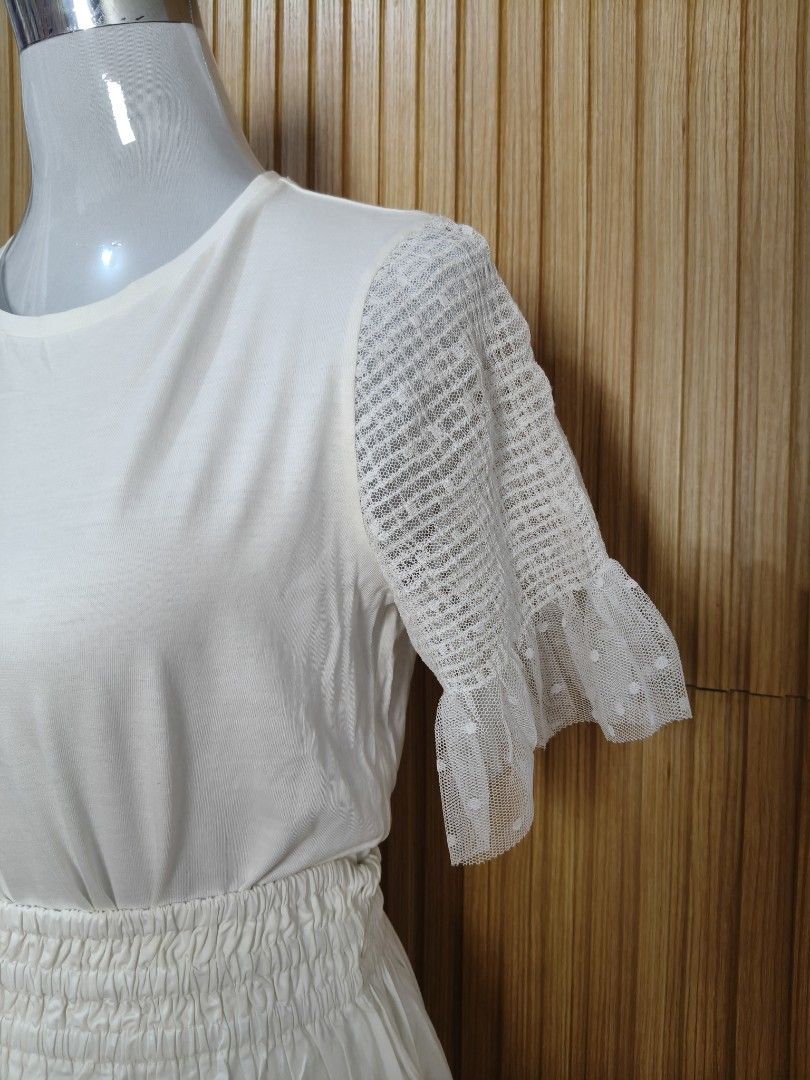Zara White Top with Sheer Sleeves (Category: Shirts) located in Taguig. Submitted by ashie_clothing (Listing ID 1469205242, Image 2). Description: - Brand: Zara - Condition: Brand new with tags (BNWT) - Size: S - Color: Crisp white - Material: Lightweight with textured details - Features: Short lace sleeves, crew neckline, regular fit - Origin: Made in Morocco - Styling: Easy to match with denim or skirts.