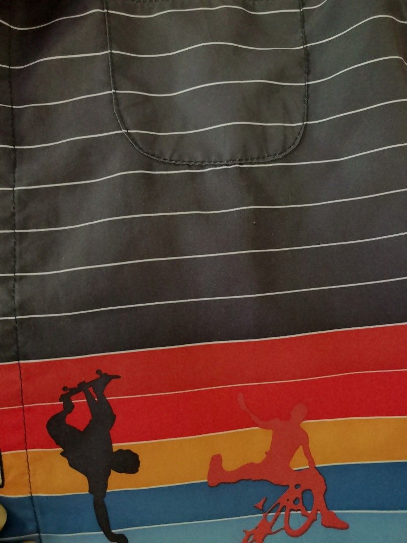 Zone Two Skate Graphic Striped Button-Up Shirt Size 7 (Category: Tshirts & Polo Shirts ) located in Samboan. Submitted by stephie_89 (Listing ID 1469220652, Image 3). Description: - Brand/Style: Zone Two short sleeve button-up shirt - Color/Design: Dark grey with horizontal white stripes and a vibrant gradient skater/BMX graphic near the hem - Features: Classic collar, front button closure, and one chest pocket - Size: Tag size 7 - Fits boys 7-10