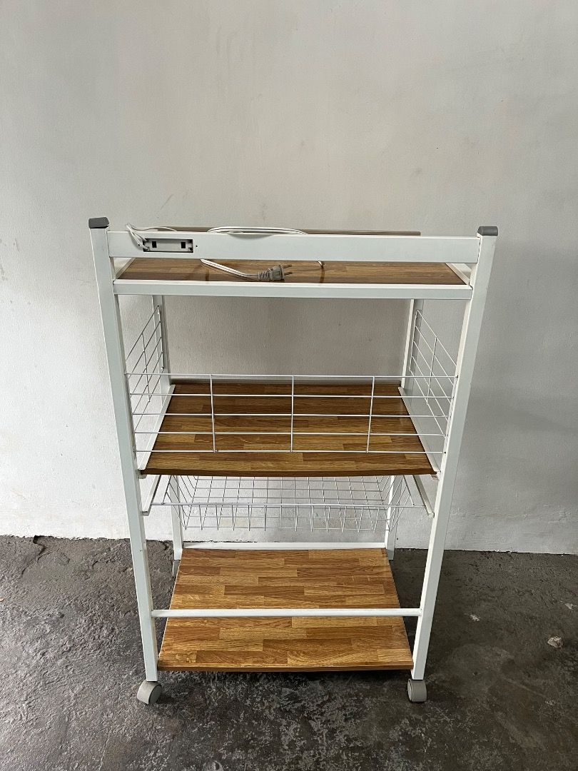 3-Tier Kitchen Trolley Rack with Power Outlet and Wheels (Category: Shelves, Cabinets & Racks) located in Cabuyao City. Submitted by rdtrmt (Listing ID 1469219105, Image 3). Description: - 3-tier rolling utility cart with a stylish wooden pattern and durable white metal frame - Built-in power strip on the top shelf for easy appliance plugging - Includes a handy wire basket near the bottom for extra organization - 4 smooth-gliding caster wheels fo