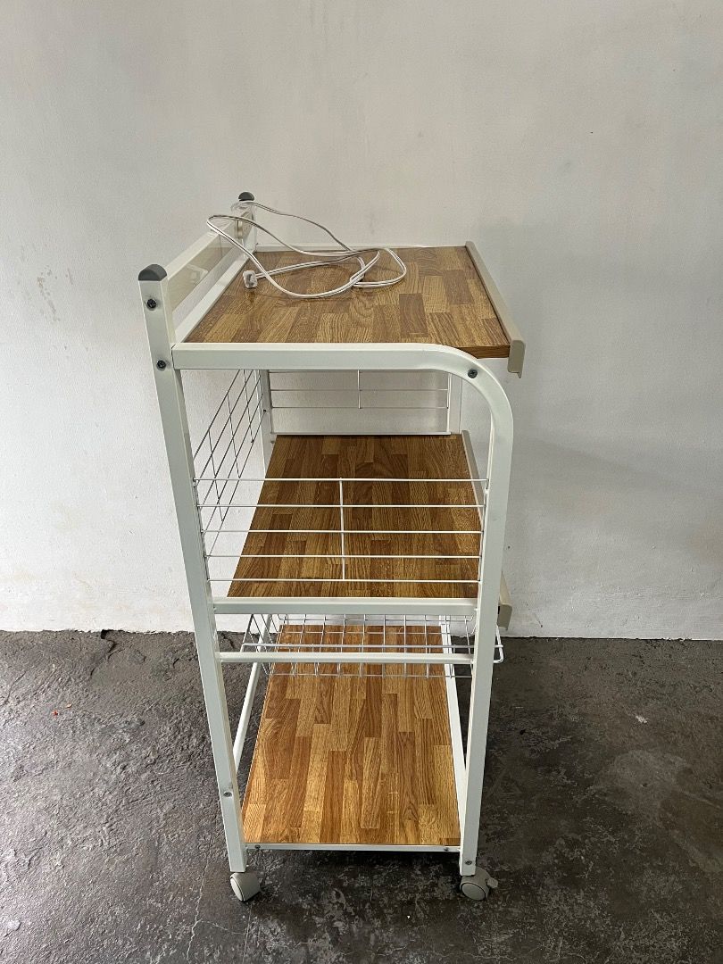 3-Tier Kitchen Trolley Rack with Power Outlet and Wheels (Category: Shelves, Cabinets & Racks) located in Cabuyao City. Submitted by rdtrmt (Listing ID 1469219105, Image 2). Description: - 3-tier rolling utility cart with a stylish wooden pattern and durable white metal frame - Built-in power strip on the top shelf for easy appliance plugging - Includes a handy wire basket near the bottom for extra organization - 4 smooth-gliding caster wheels fo