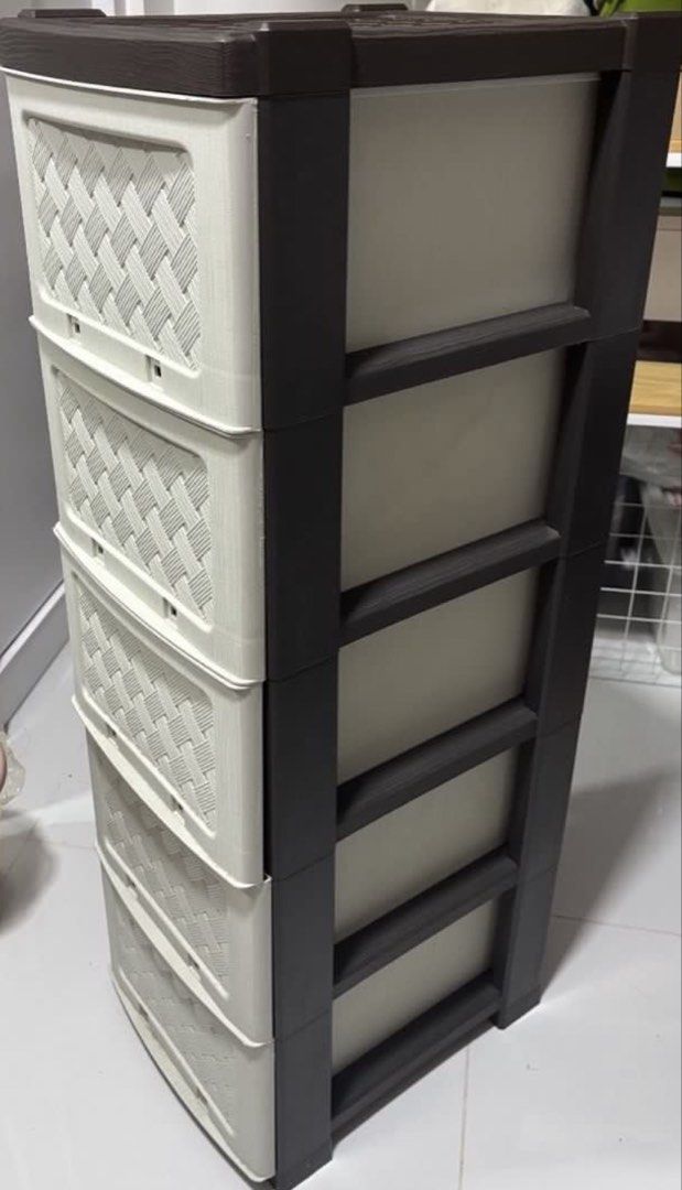5-Tier Plastic Storage Drawer Unit Wicker Pattern (Category: Shelves, Cabinets & Racks) located in Manila. Submitted by freebear_74eda4 (Listing ID 1469435202, Image 1). Description: Five-tier plastic storage drawer unit with a woven wicker pattern on the front faces. Dark brown frame with off-white or cream drawers. Overall sturdy build with some minor surface scratches on the top panel. Includes the handles and assembly clips for the drawer. Us
