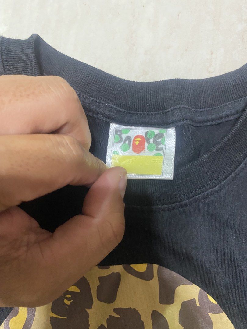 A Bathing Ape BAPE By Bathing Ape T-Shirts (Category: Activewear) located in Alburquerque. Submitted by zanegavynn43872 (Listing ID 1469490003, Image 2). Description: (Bundle of 2) - Designs: 1) Yellow leopard camo ape head with gold lettering, 2) Dark starry night galaxy camo ape head with white lettering - Material: Premium soft cotton - Details: Classic collar tags and sleeve ape tags fully intact - Style: Streetwear staples, .