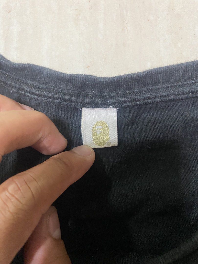 A Bathing Ape BAPE By Bathing Ape T-Shirts (Category: Activewear) located in Alburquerque. Submitted by zanegavynn43872 (Listing ID 1469490003, Image 3). Description: (Bundle of 2) - Designs: 1) Yellow leopard camo ape head with gold lettering, 2) Dark starry night galaxy camo ape head with white lettering - Material: Premium soft cotton - Details: Classic collar tags and sleeve ape tags fully intact - Style: Streetwear staples, .