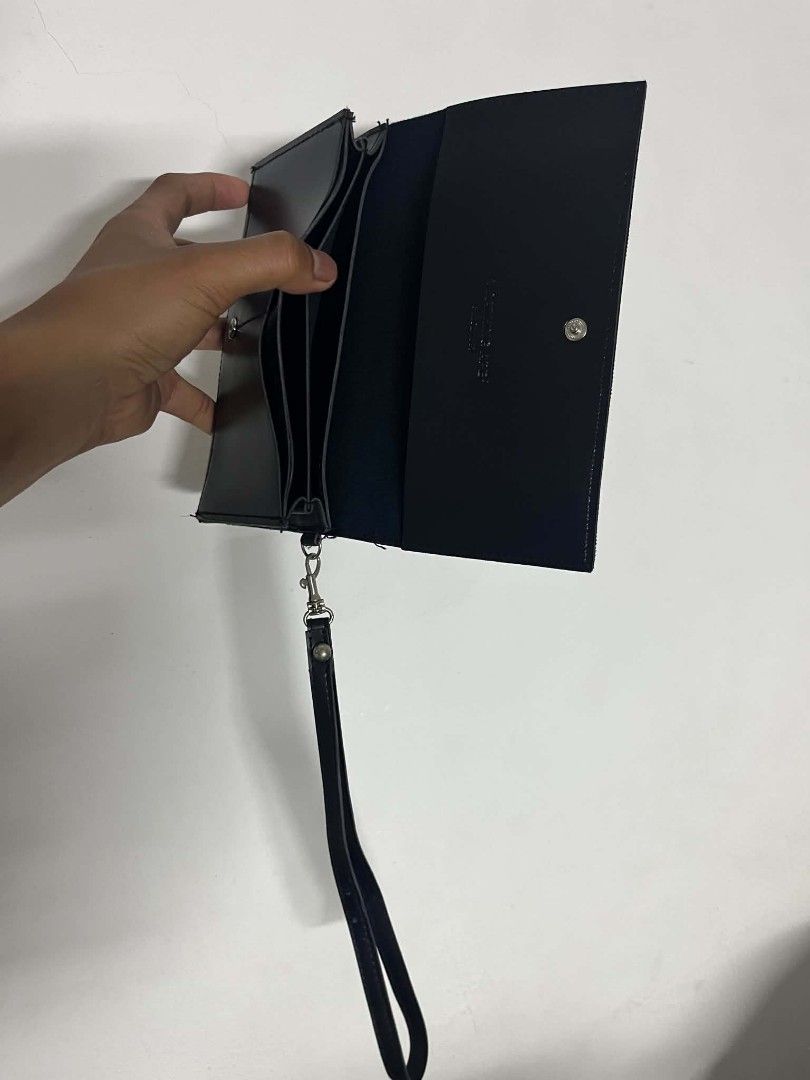 A Bathing Ape BAPE Long Wallet Black (Category: Wallets & Card Holders) located in Manila. Submitted by cleverearth.125e3f (Listing ID 1469395261, Image 2). Description: - Brand: A Bathing Ape (BAPE) - Color: Classic Black - Design: Debossed BAPE head logo on front with embossed interior branding - Storage: Multiple card slots and spacious cash compartments - Closure: Secure snap button closure - Extra: Includes a detachable wrist strap with silv