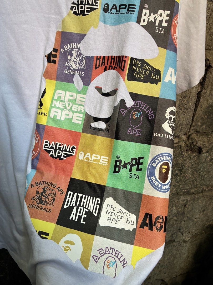 A Bathing Ape BAPE Multi Graphic Tee White (Category: Tshirts & Polo Shirts ) located in Manila. Submitted by assortedgoodsv3 (Listing ID 1469463655, Image 2). Description: - Brand: A Bathing Ape (BAPE) - Color: White - Size: Large - Material: 100% Cotton, Made in Japan - Design: Large multi-graphic ape head silhouette print with logo patches - Authenticity details: Classic collar tag and sleeve ape head tag included - Condition: Excellent / Well