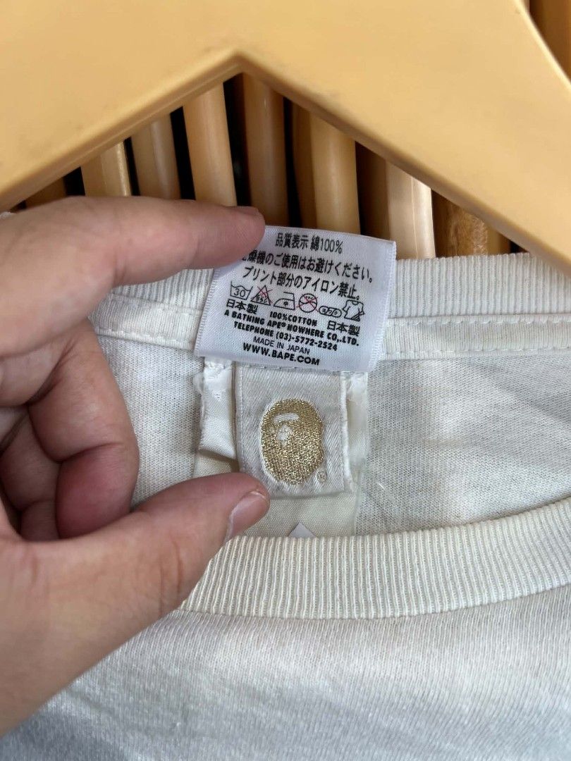 A Bathing Ape Bape Pocket Graphic Long Sleeve Tee (Category: Tshirts & Polo Shirts ) located in Urdaneta. Submitted by jayceegarage (Listing ID 1469543807, Image 3). Description: - Brand: A Bathing Ape (Bape) - Item: White Long Sleeve Shirt - Size: L - Material: 100% Cotton (Made in Japan) - Design: Front graphic of denim pocket with red pen and lighter, plus yellow rope Bape branding - Details: Iconic Bape collar tag, gold ape head washing label