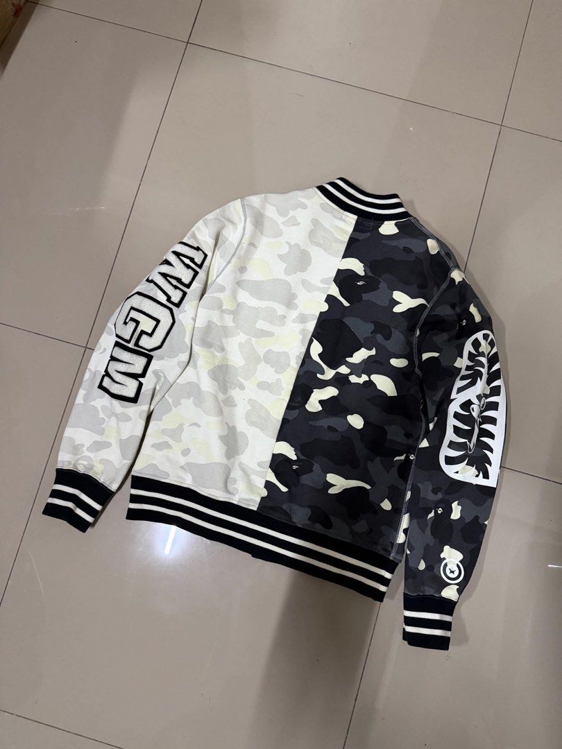 A Bathing Ape BAPE Split Shark Varsity Jacket Glow in the Dark (Category: Coats, Jackets and Outerwear) located in Manila. Submitted by sleamdaily222 (Listing ID 1469554941, Image 2). Description: - Brand: A Bathing Ape (BAPE) - Item: Split Camo Varsity Jacket - Color: Black and White (split design) - Size: Medium (M) - Details: Iconic shark face graphic, WGM chenille patch lettering, snap button closure, striped ribbed cuffs and hem - Condition: