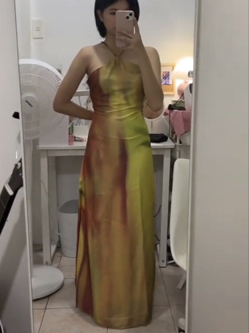 Abstract Floral Halter Maxi Dress Low Back (Category: Dresses) located in Manila. Submitted by cardonesem04209 (Listing ID 1469501349, Image 3). Description: - Style: Long halter neck maxi dress with a dramatic low cowl back - Design: Vibrant abstract watercolor floral pattern in yellow, pink, and green - Details: Thin crisscross back straps and smooth fabric with a subtle sheen - Condition: Worn once for a mirror selfie, practically untouched an