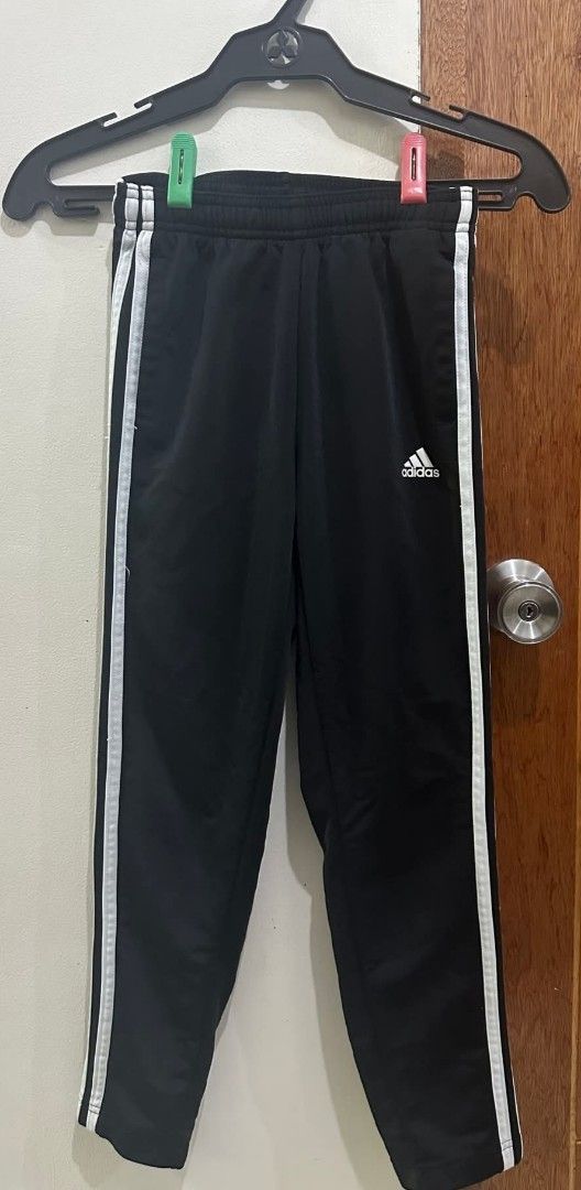 Adidas Black Track Pants with White Stripes (Category: Joggers) located in Manila. Submitted by livewater-0f48 (Listing ID 1469518644, Image 1). Description: - Authentic Adidas track pants in classic black - Iconic white side stripes and printed logo near the pocket - Comfortable elastic waistband with adjustable drawstring - Standard athletic cut ideal for workouts, lounging, or daily wear - Excellent, well-kept condition with clean stitching - 