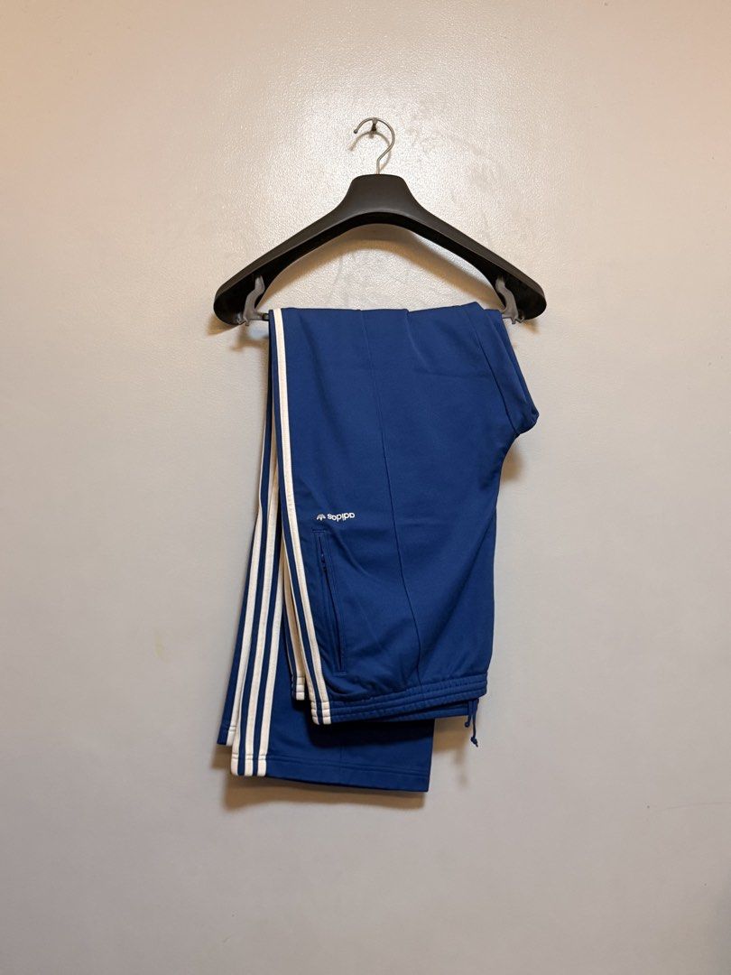 Adidas Blue Track Pants Size 2XL (Category: Joggers) located in Manila. Submitted by swiftgem.eeb06e (Listing ID 1469515492, Image 1). Description: - Brand/Style: Classic blue Adidas track pants with iconic white side stripes - Size: 2XL (Made in Indonesia) - Material: Comfortable cotton and polyester blend - Features: Adjustable drawstring waist and secure front zip pockets - Condition: Great for casual wear or workouts - Size: 2XL - Dims: 19 x 