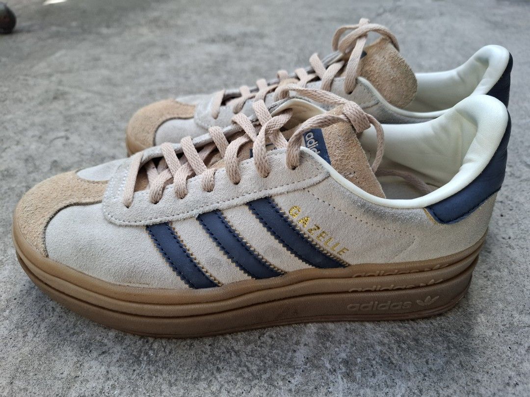 Adidas Gazelle Bold Clear Brown Navy (Category: Sneakers) located in Makati City. Submitted by itemsforless2025 (Listing ID 1469483850, Image 2). Description: - Brand: Adidas Gazelle Bold (Triple-stacked platform) - Colorway: Clear Brown suede with Navy Blue stripes and heel tab - Details: Iconic gold foil branding, beige laces, and classic gum rubber sole - Condition: Excellent, clean soles and crisp suede texture - Fit & Comfort: Comfortable pa