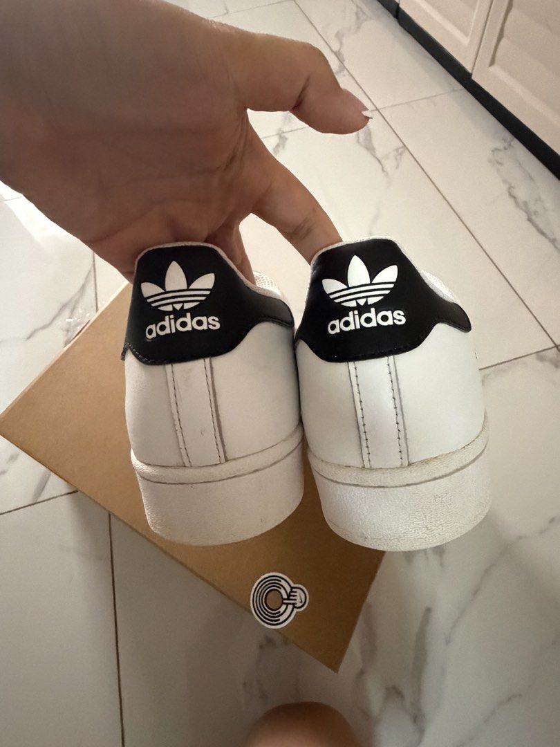 Adidas Superstar White Black Men Size 10 (Category: Sneakers) located in Manila. Submitted by monstershaaa (Listing ID 1469405562, Image 2). Description: bought in hongkong used 1-2x only and keep na Original 💯 * wala na po box - Yung box na meron ako pwede replacement is nike shoes box RFS : hirap si Husband gamitin kasi medyo malapad ang paa 😅 ‼️‼️ paki clean na lang po need lang i wash since na keep sya kaya may discoloration - Normal issue 
